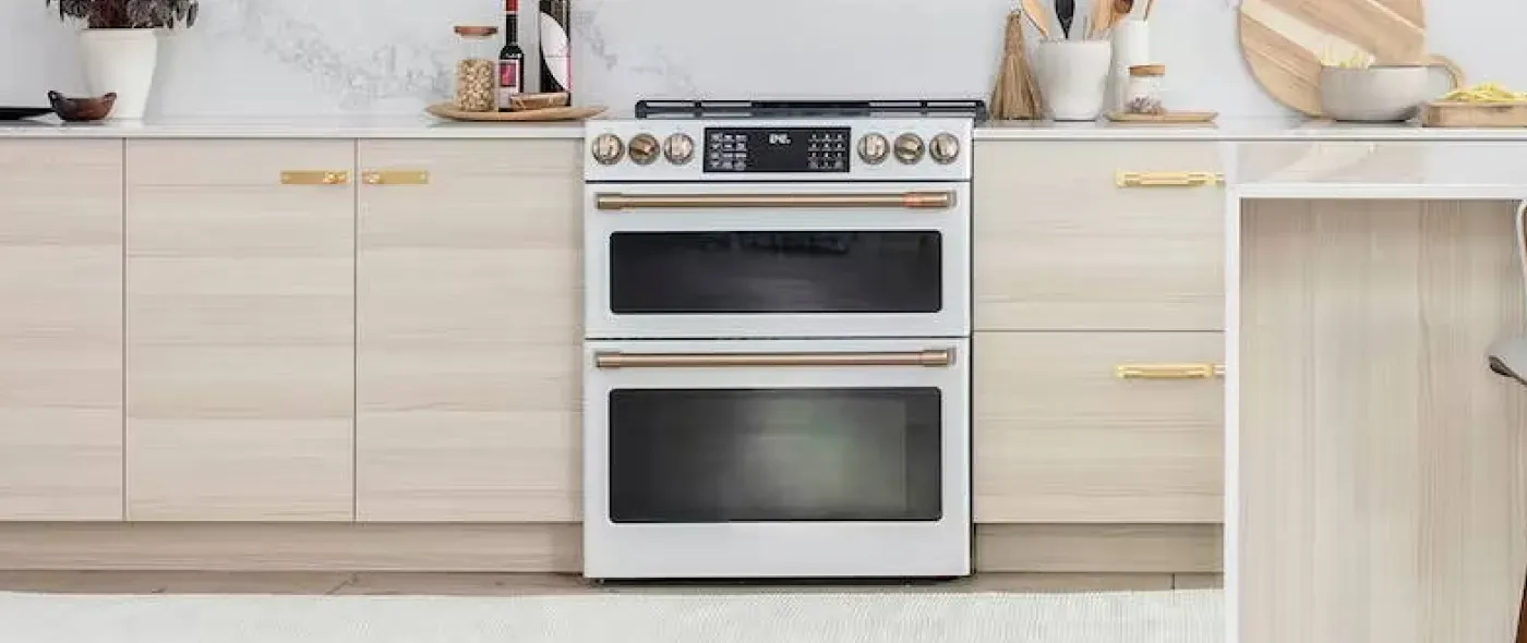 slide in range double oven in a kitchen with white washed wooden cabinets